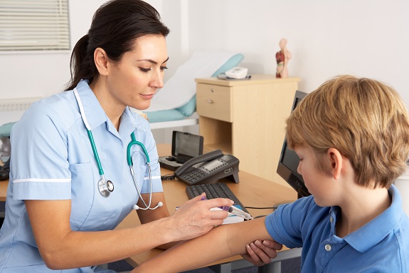 Nurse giving injection to young boy